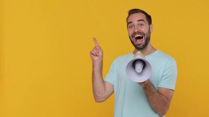 Sticker - Excited fun young man in basic casual blue t-shirt hold in hand scream in megaphone announces discounts sale Hurry up pointing finger aside on workspace promo area isolated on yellow background studio