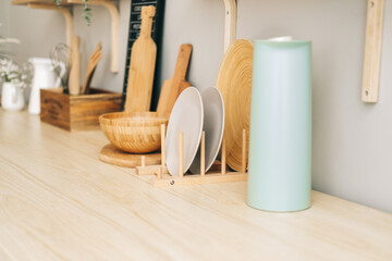 Canvas Print - Kitchenware on the wooden table in modern bright kitchen.