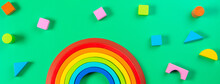 Baby Kids Toy Background. Wooden Stacking Rainbow And Colorful Blocks On Light Green Background. Top View