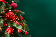 © elenabdesign - Decorated with ornaments and lights Christmas tree on green background. Merry Christmas and Happy Holidays greeting card, frame, banner. New Year. Noel