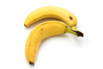 Bananas with some dark spots with shadow isolated on white background. Closeup, selective focus. Two old banana with spots, on a white isolated backgroun