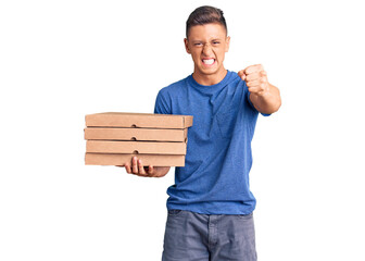 Wall Mural - Young handsome hispanic man holding delivery pizza box annoyed and frustrated shouting with anger, yelling crazy with anger and hand raised