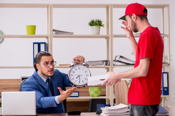 Young man delivering pizza to the office in time management conc