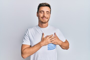 Wall Mural - Handsome caucasian man wearing casual clothes smiling with hands on chest, eyes closed with grateful gesture on face. health concept.