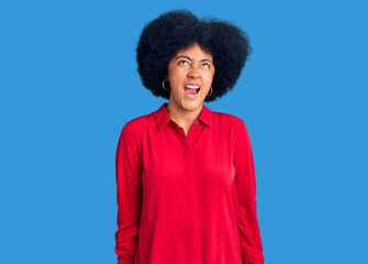 Sticker - Young african american girl wearing casual clothes angry and mad screaming frustrated and furious, shouting with anger. rage and aggressive concept.