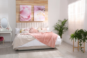 Wall Mural - Stylish room interior with large comfortable bed and beautiful paintings