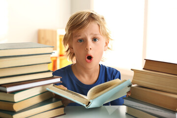 Sticker - Emotional little boy doing homework at table indoors