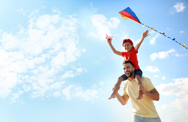 Sticker - Happy father and his child playing with kite on sunny day. Spending time in nature