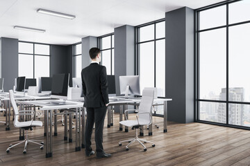 Wall Mural - Businessman standing in luxury office