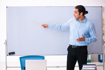 Sticker - Young handsome teacher in front of whiteboard