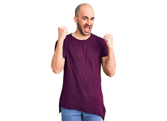 Young handsome man wearing casual t shirt screaming proud, celebrating victory and success very excited with raised arms