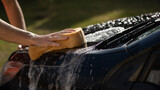Fototapeta  - close up of a men wahing a car