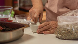 Fototapeta  - close up of a woman making a tea blend