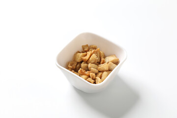 Delicious fat food, fried greaves pork in a bowl on white background.