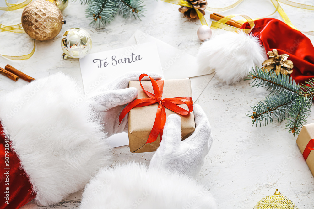 Santa with Christmas gift on white background