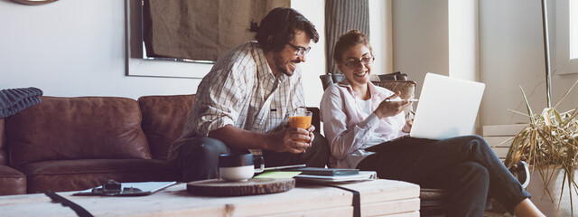 Group of two people with laptops in small loft office. Man and woman working together. Good new ideas. Wide screen, panoramic