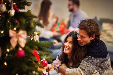 Wall Mural - Adult couples having fun over Christmas tree