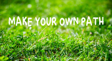 Motivational Quote Make Your Own Path On Green Grass Garden Background.