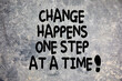 Change happens one step at at time quote written on stone background in nature. Development, success and improvement