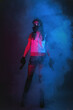 © Dmitriy - Girl with a toy guns in hands in the smoke. Cyberpunk concept.