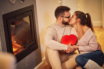 Wall Mural - Adult couple with present over fireplace