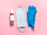 Fototapeta  - Medical protective mask, latex gloves, hand sanitizer on a pastel pink background. Individual, disposable hygiene equipment. Quarantine healthcare, hygiene and coronavirus protection concept.