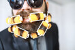 Cheerful hipster man with curlers in a beard. Surprised man with glasses looks in front.