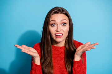 Wall Mural - Annoyed frustrated girl difficult question dont know answer shrug shoulders isolated blue color background