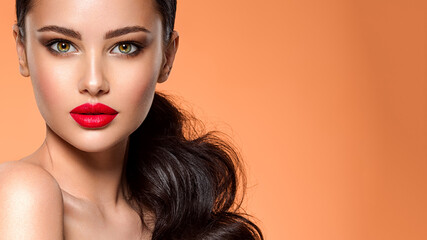 Wall Mural - beautiful white girl with a red lipstick on lips. stunning brunette girl with long hair tail. closeu