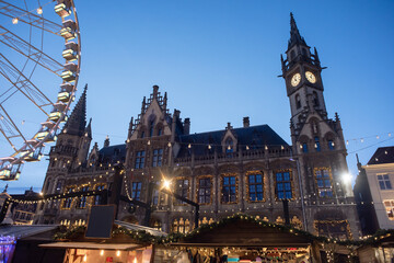 Wall Mural - Christmas market in Europe, Ghent, Belgium. Main town square with decorated tree and lights. Traditional Christmas fair concept.