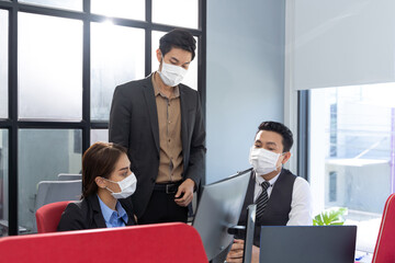 Group of Asian business people meeting and working in office and wear mask for protect  prevent infection corona virus covid 19.