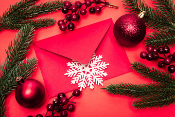 Canvas Print - top view of Christmas decoration and envelope on red background