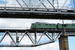 locomotive of the train goes over the bridge over the bridge.