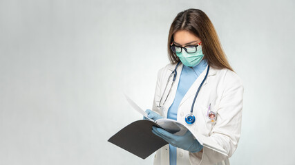 Young female caucasian doctor reading documents.