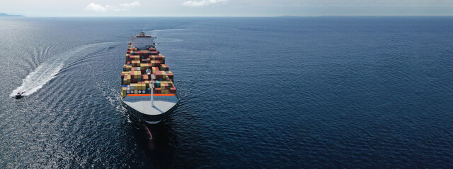 Aerial drone panoramic ultra wide photo of industrial truck size container tanker ship cruising in open ocean deep blue sea