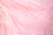 Beautiful bright pink tulle with shiny beads background. Draped background of pink powdery fabric, texture. Copy space