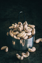 Wall Mural - Raw unpeeled cashew nuts on a dark background