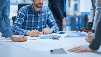 Poster - Busy Diverse Team of Computer Engineers and Specialists Gather Around Conference Table and Discuss Electrical Prototype, Drafts and Blueprints, Find Problem Solutions. Office Meeting Room.