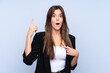 © luismolinero - Young Brazilian business woman over isolated blue background with surprise facial expression