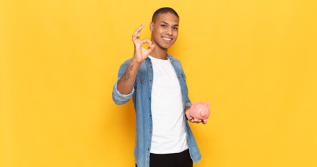 Sticker - young black man feeling happy, relaxed and satisfied, showing approval with okay gesture, smiling