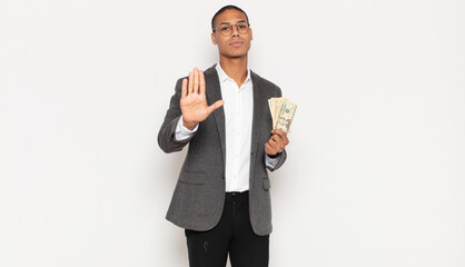 Sticker - young black man looking serious, stern, displeased and angry showing open palm making stop gesture