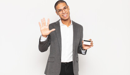 Sticker - young black man smiling and looking friendly, showing number five or fifth with hand forward, counting down