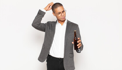 Wall Mural - young black man feeling puzzled and confused, scratching head and looking to the side