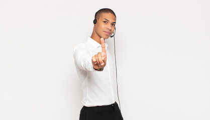 Wall Mural - young black man smiling proudly and confidently making number one pose triumphantly, feeling like a leader