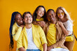 © Roman - diversity, race, ethnicity and people concept. international group of happy friendly smiling men and women isolated on yellow background, studio shoot