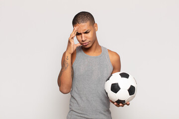 Canvas Print - young black man feeling bored, frustrated and sleepy after a tiresome, dull and tedious task, holding face with hand