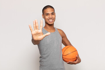 Sticker - young black man smiling and looking friendly, showing number five or fifth with hand forward, counting down