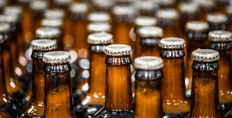 Banner Beer bottles on conveyor production line. Brewery industry food factory manufacturing