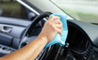 © svetamart - Cleansing car interior and wheel. Male hand  disinfecting vihicle inside