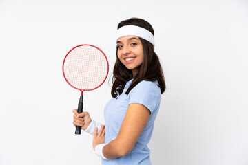 Young badminton player woman over isolated white background with arms crossed and looking forward